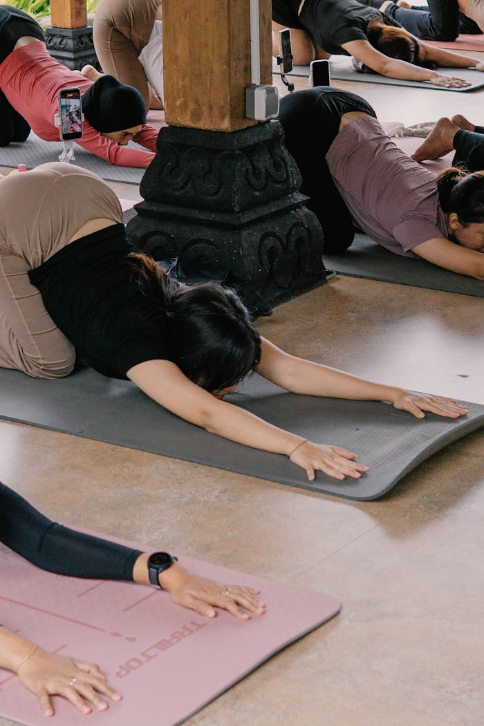 Group yoga session with diverse participants in a serene outdoor setting.
